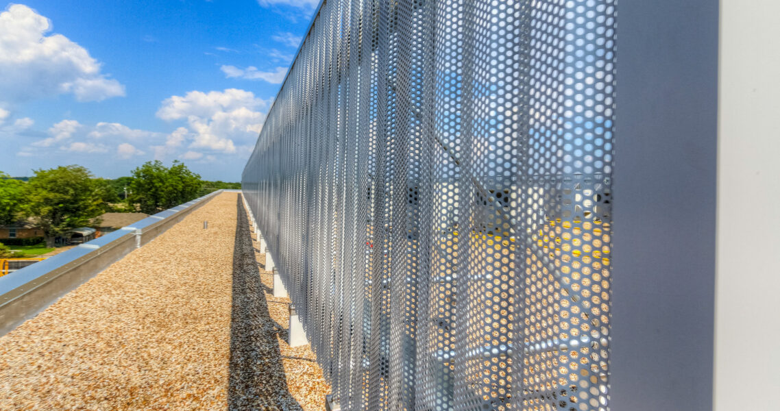 Perforated equipment screen panel on school rooftop