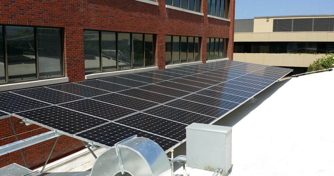 Silverback solar racking system on office building rooftop supporting over 60 solar panels